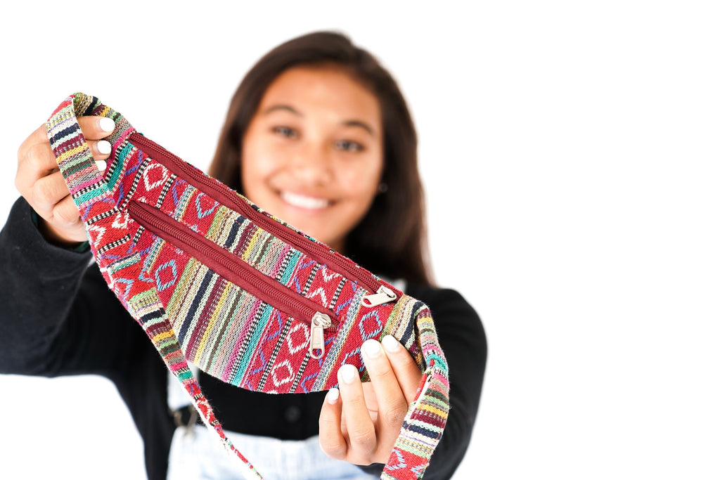 Person holding a colorful patterned bag against a white background