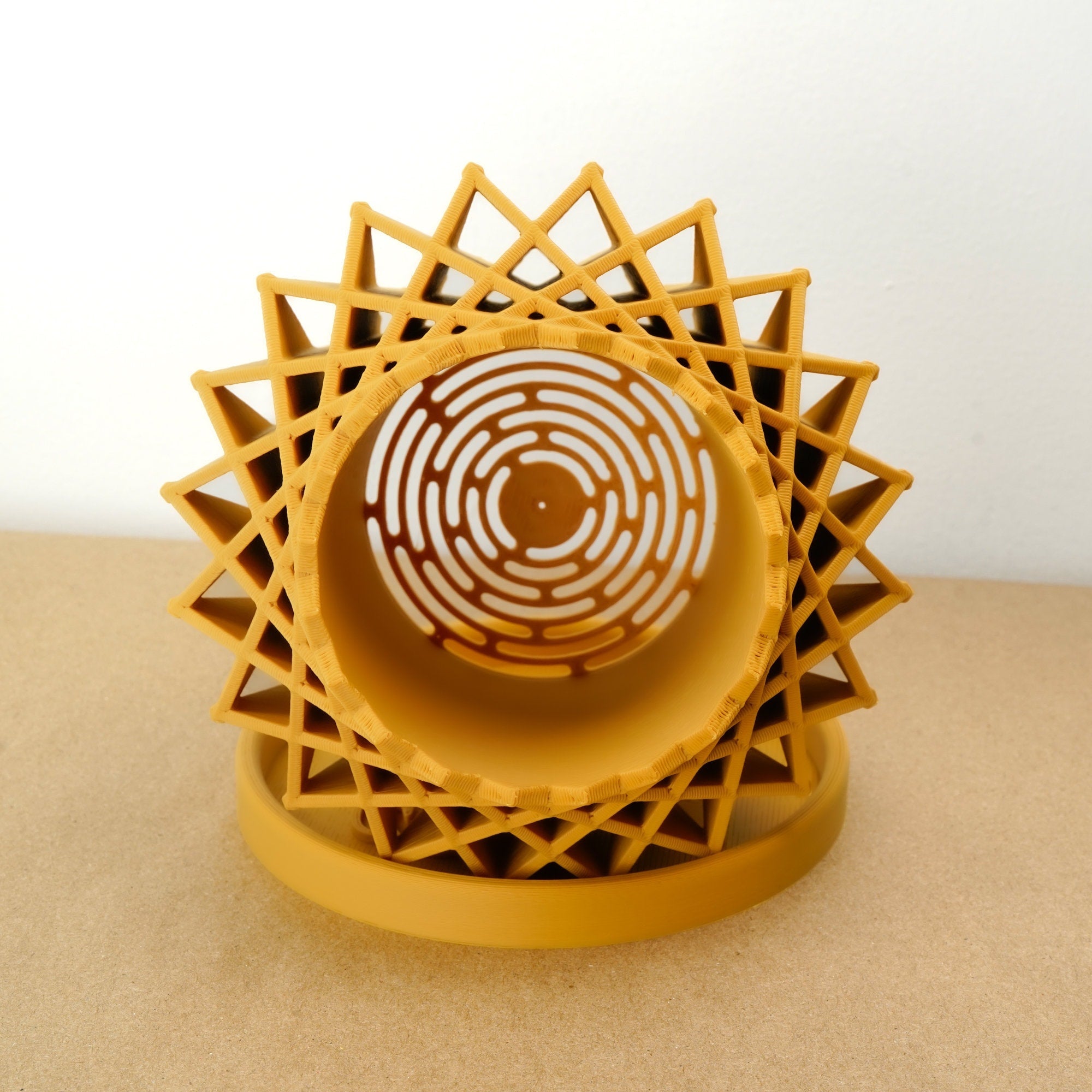 Yellow geometric 3D printed planter on a beige surface with a white background