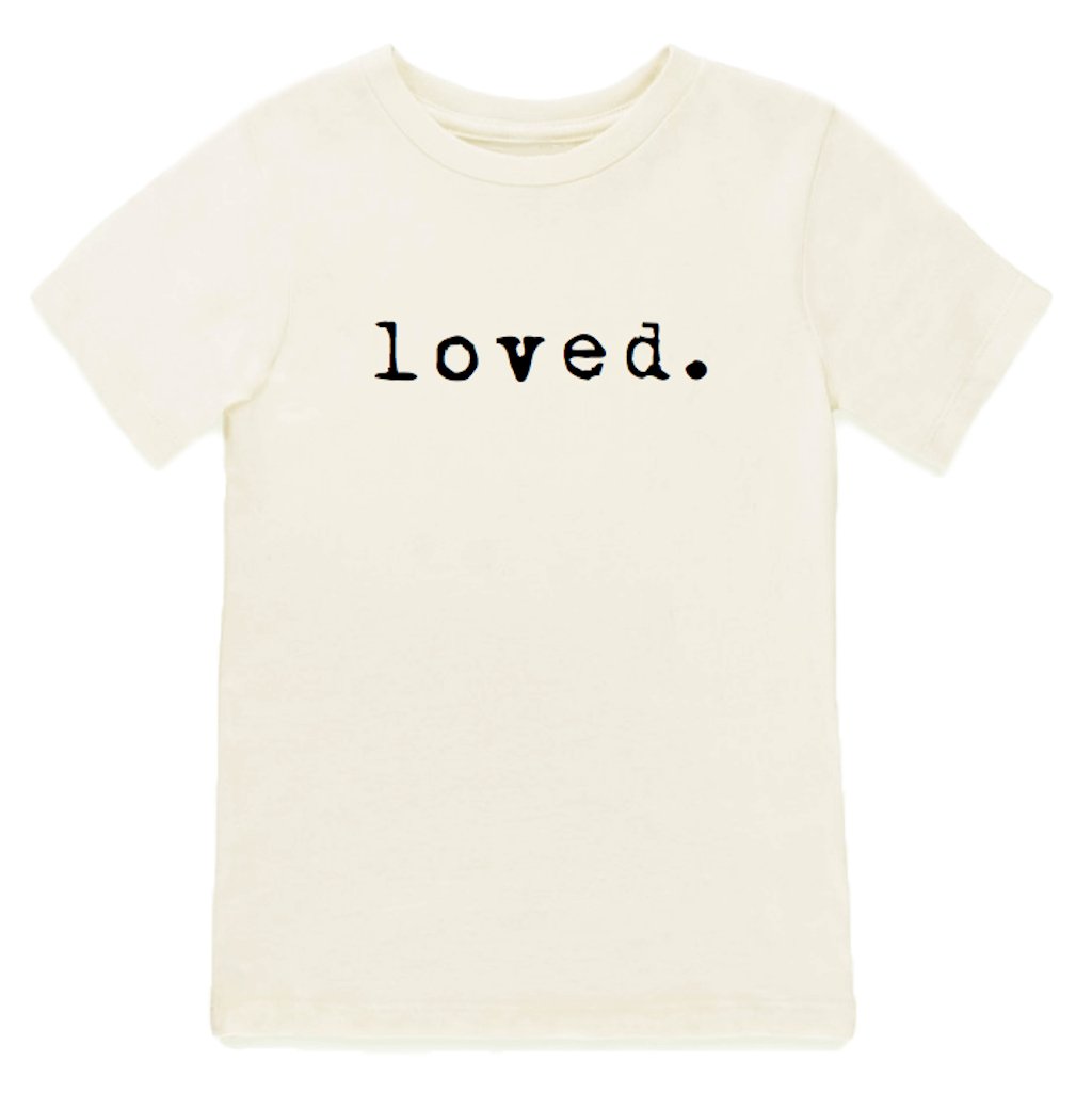 White t-shirt with 'loved.' text on a white background