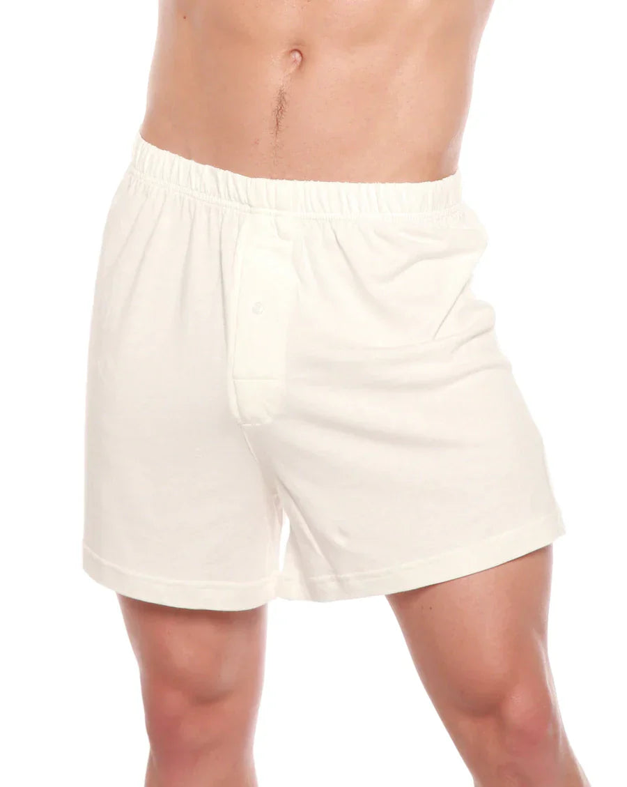 White boxer style underwear worn by a person on a white background