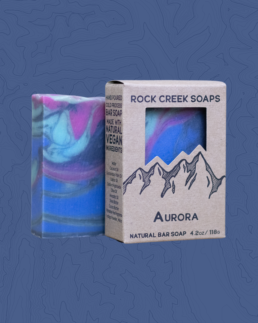 Rock Creek Soaps Aurora natural bar soap with packaging on a blue background