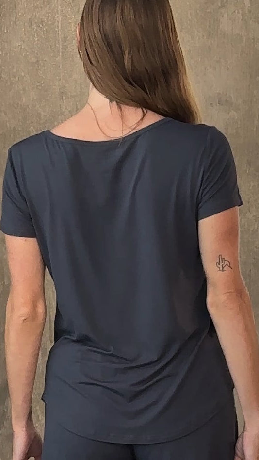 Person wearing a dark blue outfit against a neutral background