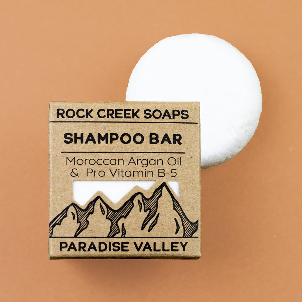 Rock Creek Soaps 'Paradise Valley' shampoo bar with packaging on a brown background. Contains Moroccan Argan Oil and Pro Vitamin B-5
