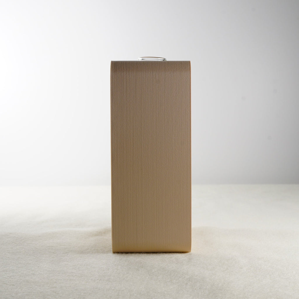 Side view of a beige rectangular vase on a light gray background