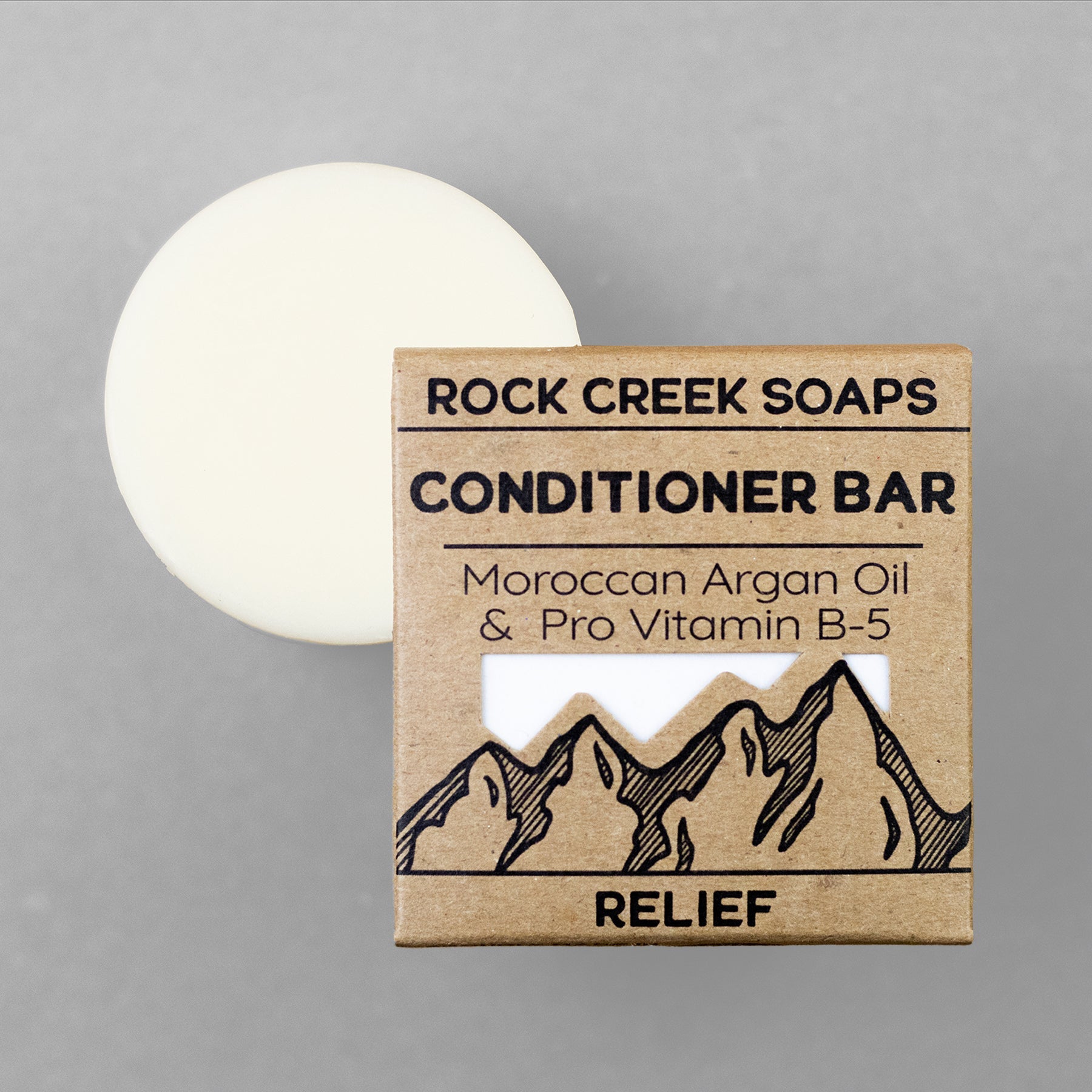 Rock Creek Soaps conditioner bar with packaging on a gray background