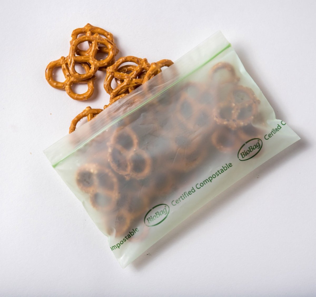 Certified compostable bag with pretzels on a white background