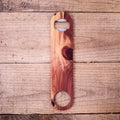 Wooden bottle opener on a wooden surface