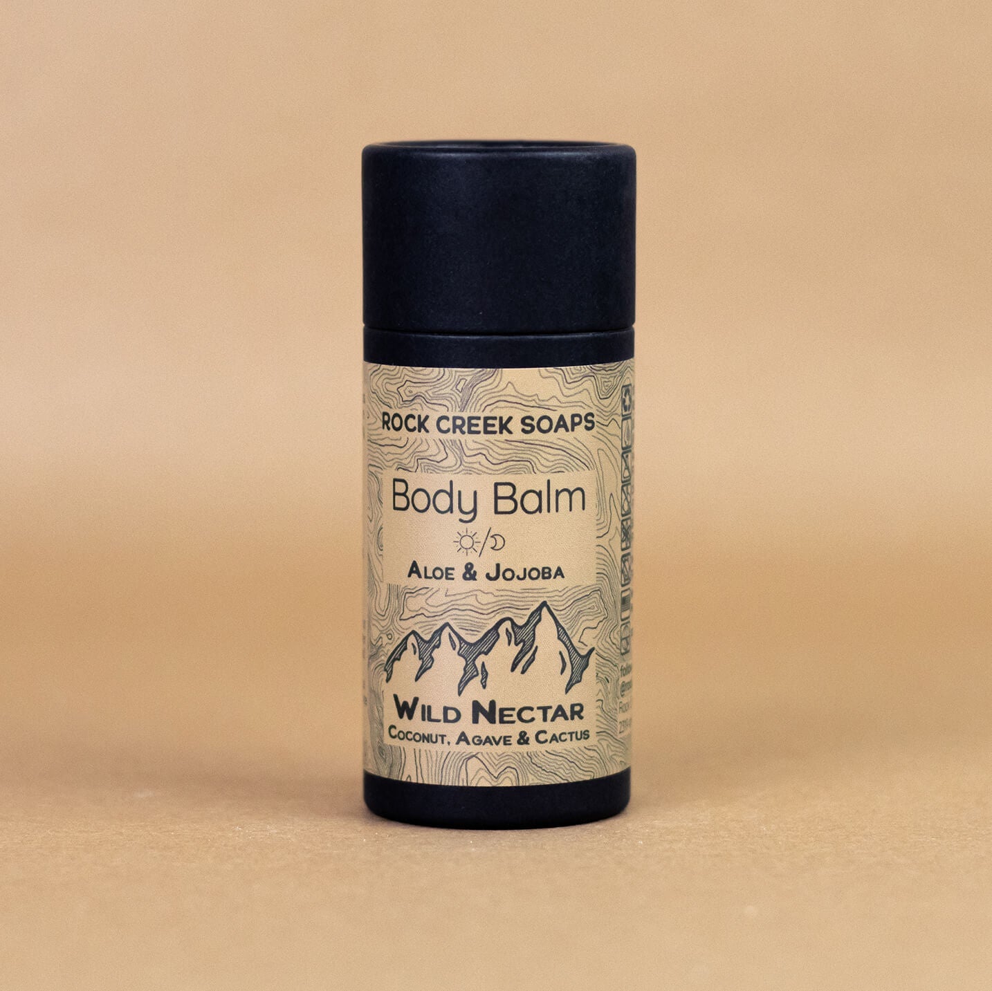 Body balm container with 'Rock Creek Soaps' label on a beige background