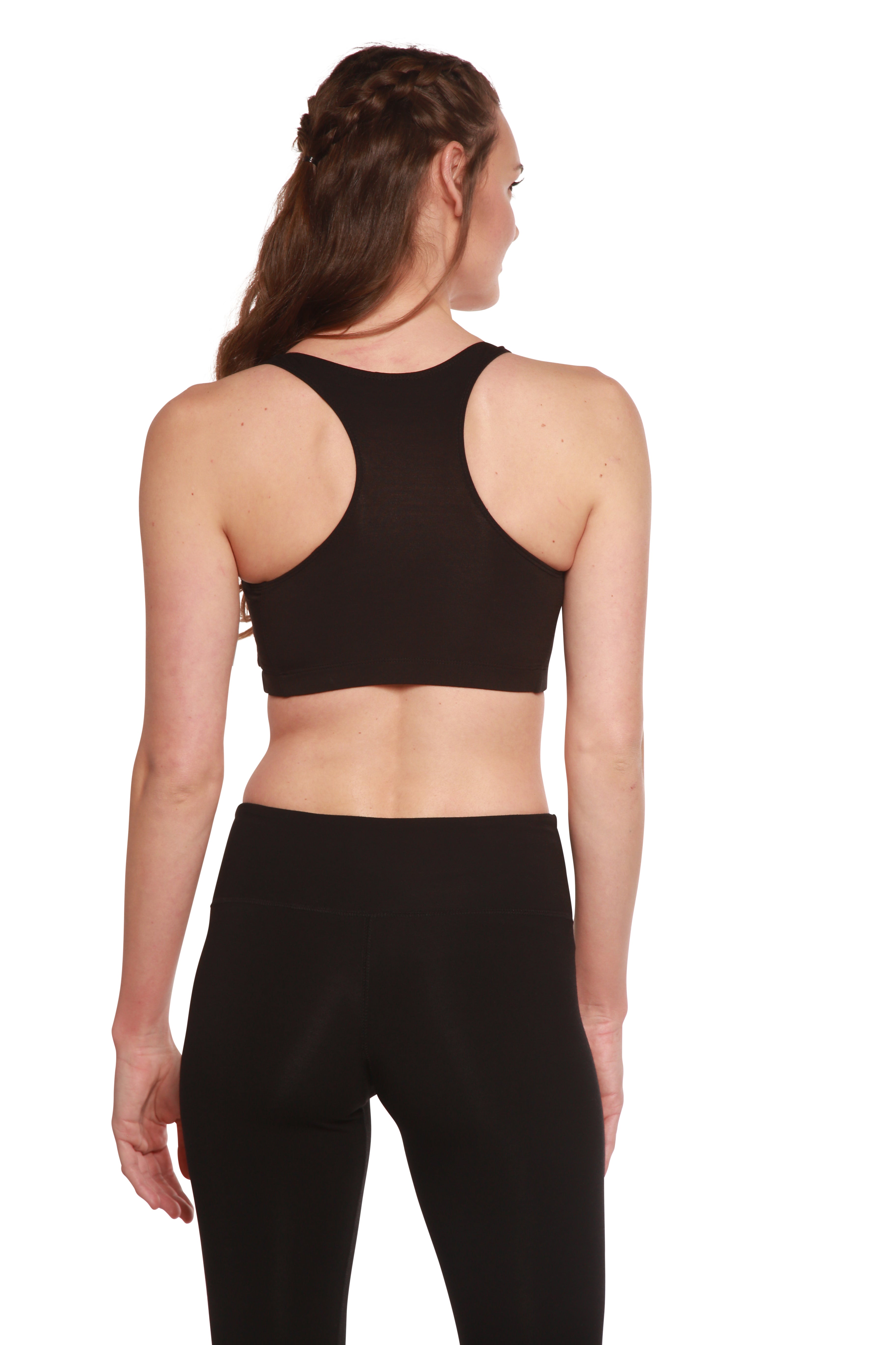 Woman wearing a black sports bra and leggings on a white background