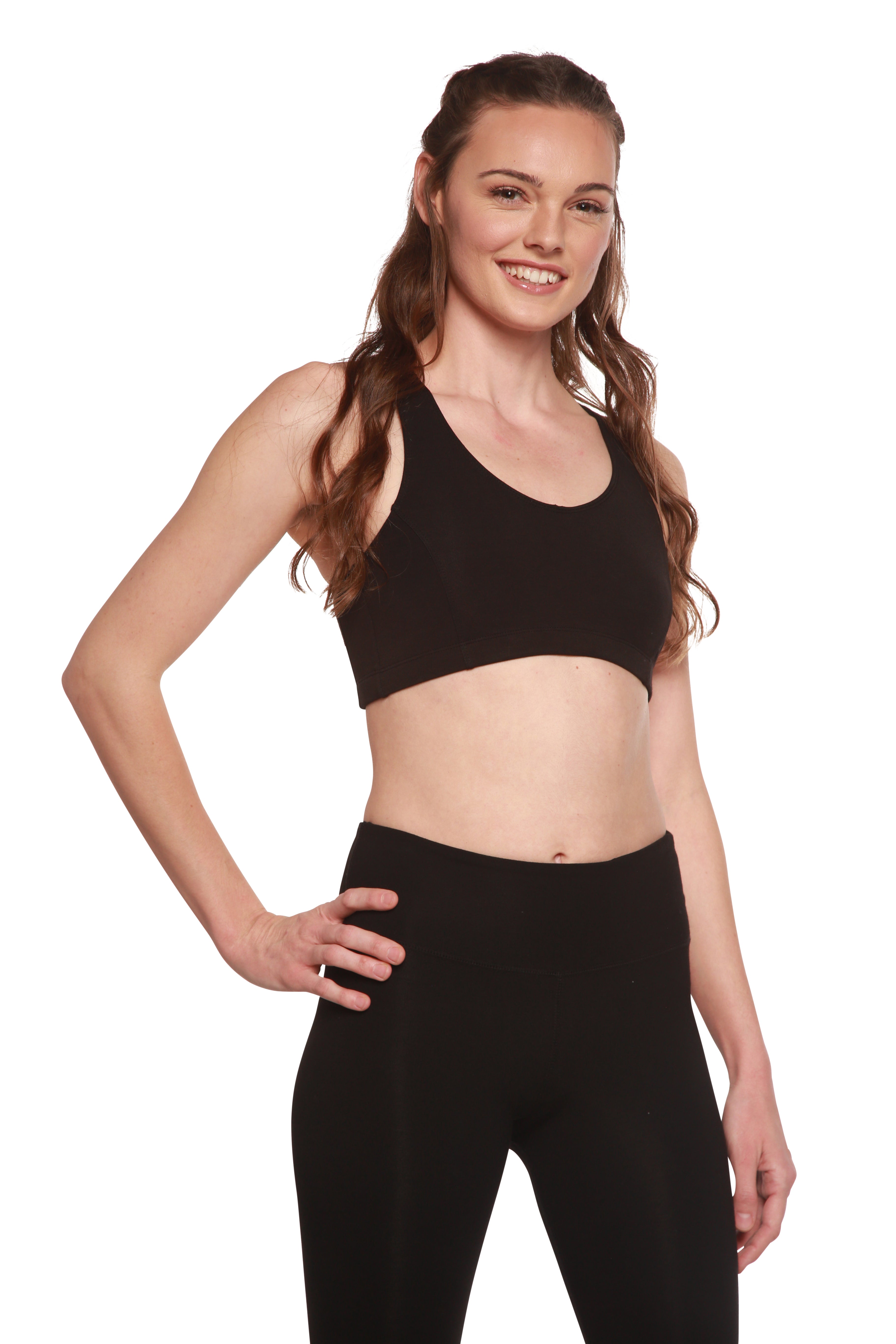 Woman wearing a black sports bra and leggings on a white background