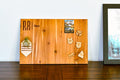 Wooden magnetic board with decorative magnets on a wooden surface