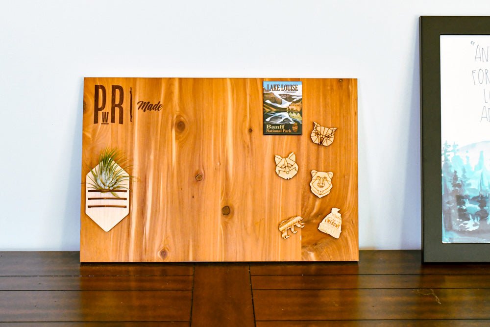 Wooden magnetic board with decorative magnets on a wooden surface